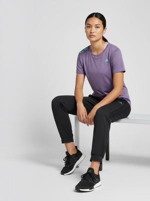 FTFO || BIG BRAND LOW PRICE Adidas Adizero purple slim fit running tee worn by a model sitting on a white bench