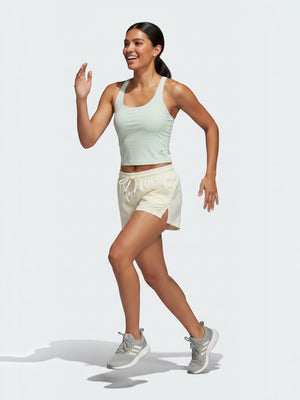 FTFO || BIG BRAND LOW PRICE Adidas cropped tank top in light green with AEROREADY fabric worn by a female runner.