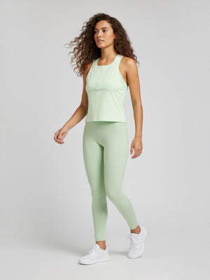 FTFO || BIG BRAND LOW PRICE model wearing a light green Adidas Techfit crop training tank top and matching leggings.