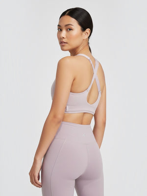 Model wearing a light purple Adidas FastImpact Luxe high-support sports bra with cross-back straps by FTFO || BIG BRAND LOW PRICE