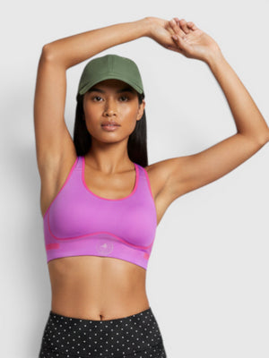 FTFO || BIG BRAND LOW PRICE model wearing a purple Adidas by Stella McCartney high-support sports bra and polka dot shorts