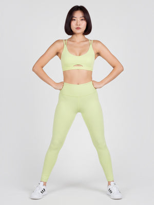 Model mengenakan set yoga Adidas berwarna hijau muda dari FTFO || BIG BRAND LOW PRICE dengan bra strappy dan legging