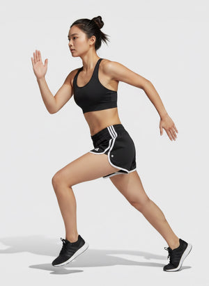 Pelari wanita memakai celana lari Adidas Own the Run hitam dengan detail garis putih dari FTFO || BIG BRAND LOW PRICE