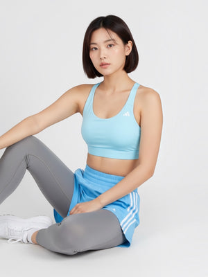 FTFO || BIG BRAND LOW PRICE Adidas light blue medium-support sports bra worn by a model with grey leggings and shorts