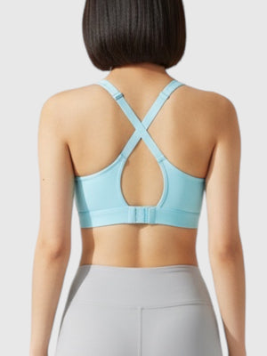 Model wearing a light blue Adidas medium-support sports bra with racerback straps and grey leggings from FTFO || BIG BRAND LOW PRICE