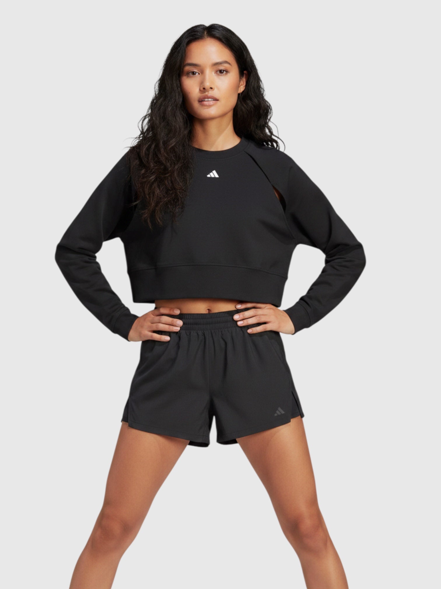 Model mengenakan Adidas Power AEROREADY crop sweatshirt hitam dengan desain lengan unik dari FTFO || BIG BRAND LOW PRICE