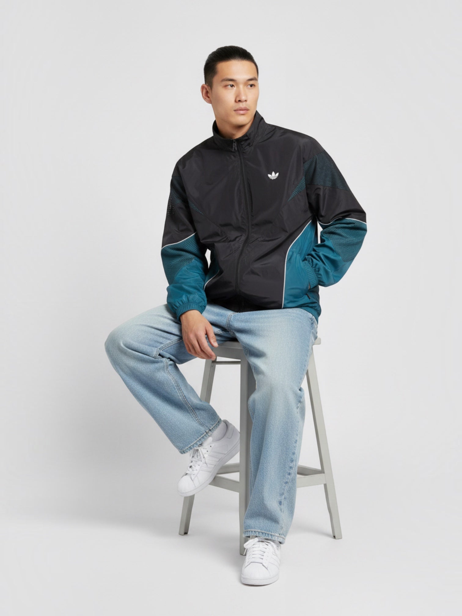 FTFO || BIG BRAND LOW PRICE Adidas Cutline track top in black and teal with full zip, worn by a man on a stool.