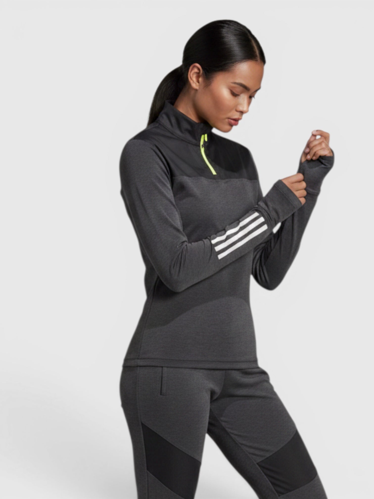 FTFO || BIG BRAND LOW PRICE model wearing a charcoal grey Adidas long sleeve gravel cycling jersey with reflective details
