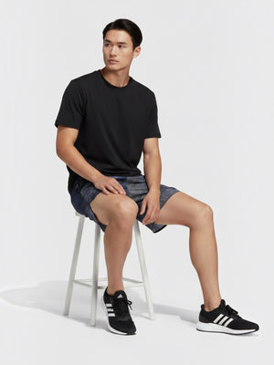 FTFO || BIG BRAND LOW PRICE Adidas B HIIT training shorts in blue patterned fabric worn by a man sitting on a stool