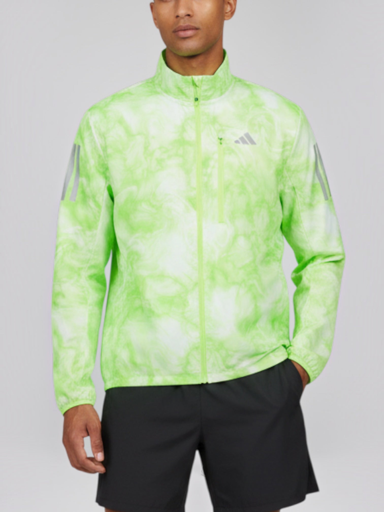 Male model wearing FTFO || BIG BRAND LOW PRICE Adidas Own the Run windproof running jacket in neon green tie-dye