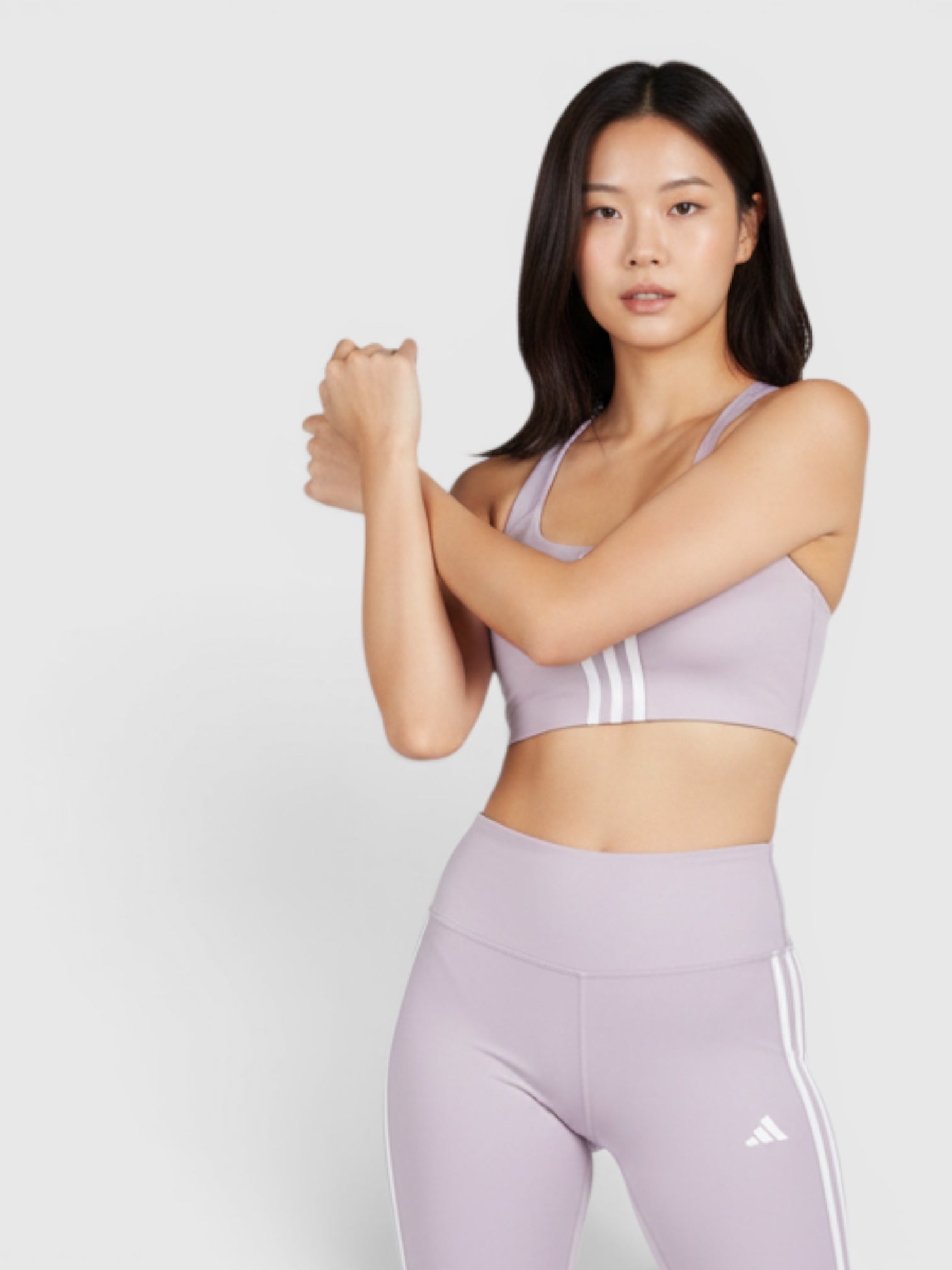 FTFO || BIG BRAND LOW PRICE model wearing a light purple Adidas medium support sports bra and matching biker shorts