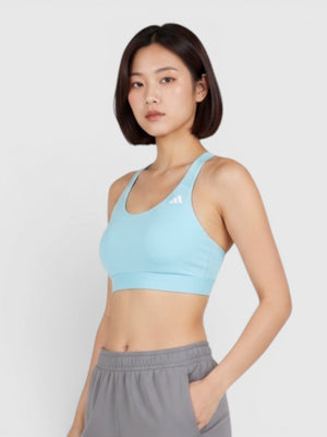 Model wearing a light blue Adidas Ultimate medium-support sports bra and grey joggers from FTFO || BIG BRAND LOW PRICE