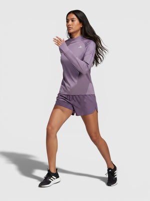 Model wanita mengenakan Adidas Ultimate Sweatshirt berwarna ungu dengan fitur thumbholes dan teknologi AEROREADY dari FTFO || BIG BRAND LOW PRICE