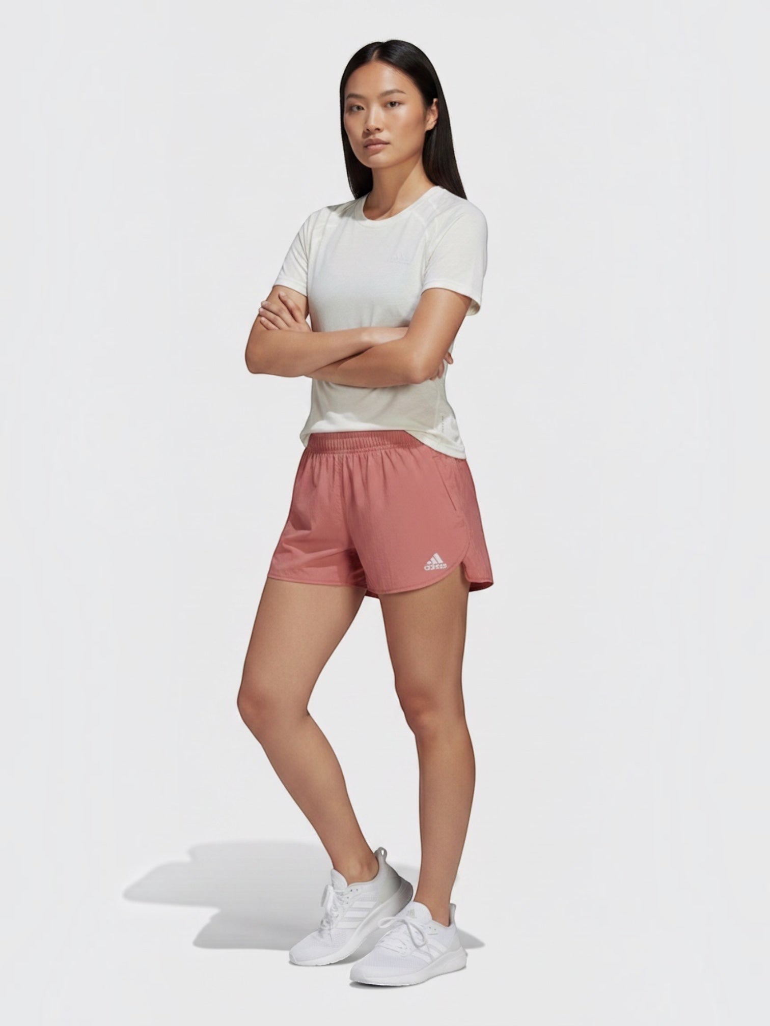 FTFO || BIG BRAND LOW PRICE Adidas XCITY running tee in white worn by a female model with pink shorts and sneakers