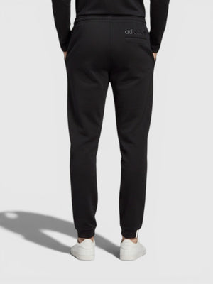 Pria mengenakan celana jogger hitam Adidas dari FTFO || BIG BRAND LOW PRICE dengan potongan regular dan manset elastis