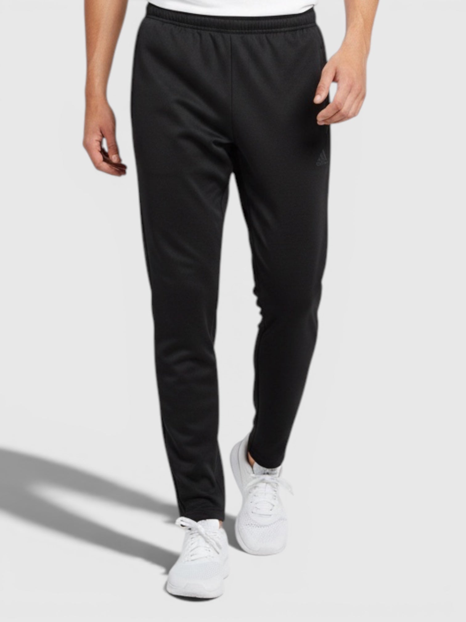 Model pria mengenakan celana olahraga Adidas W Tiro berwarna hitam dengan potongan ramping dari FTFO || BIG BRAND LOW PRICE