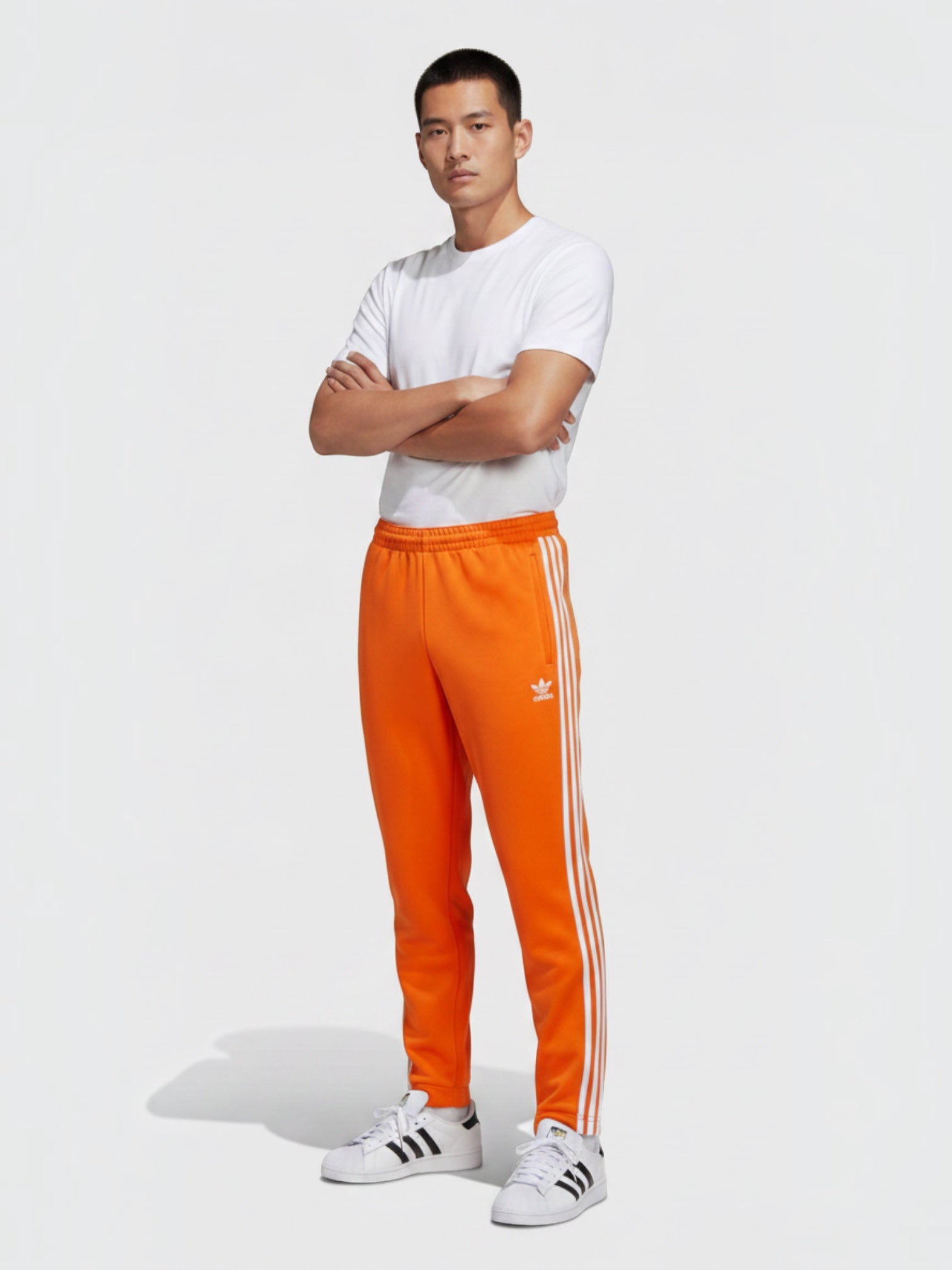 FTFO || BIG BRAND LOW PRICE celana track Adidas Adicolor Classics SST oranye slim fit dengan detail 3-Stripes putih