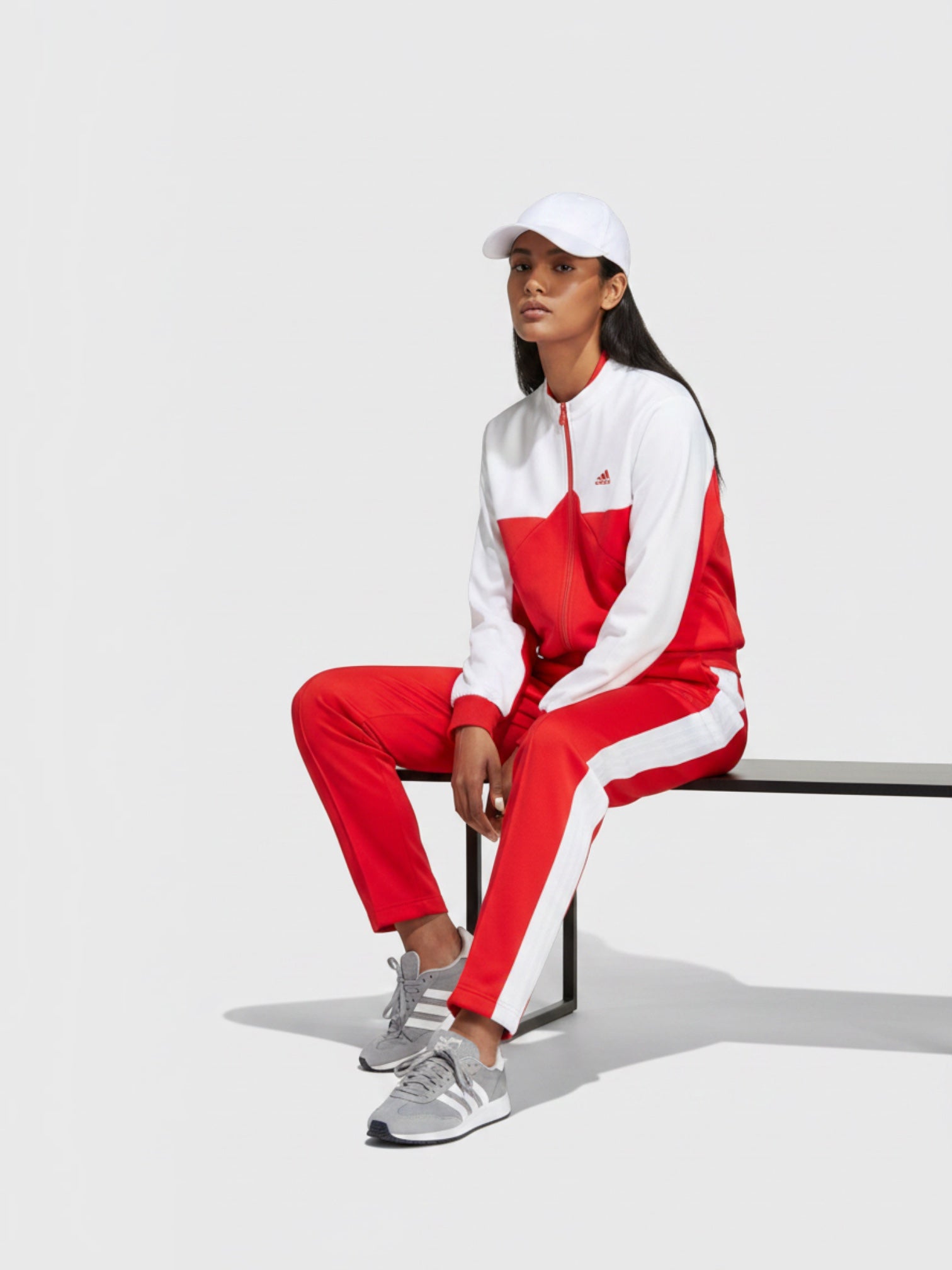Model wanita mengenakan jaket track Adidas W Tiro CB TT warna merah putih dengan celana senada dari FTFO || BIG BRAND LOW PRICE