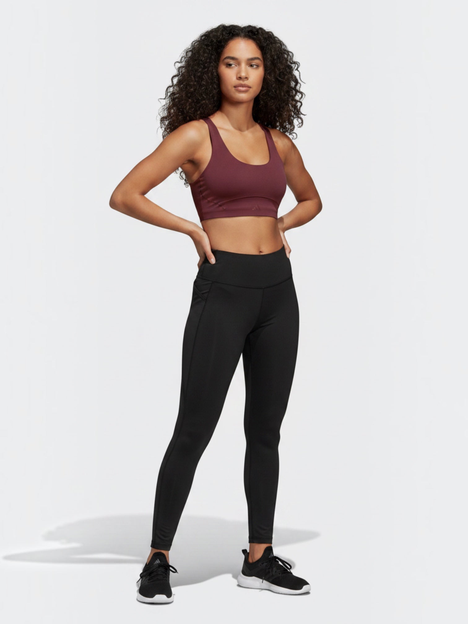 FTFO || BIG BRAND LOW PRICE model wearing a maroon Adidas Adisoft medium-support sports bra and black leggings
