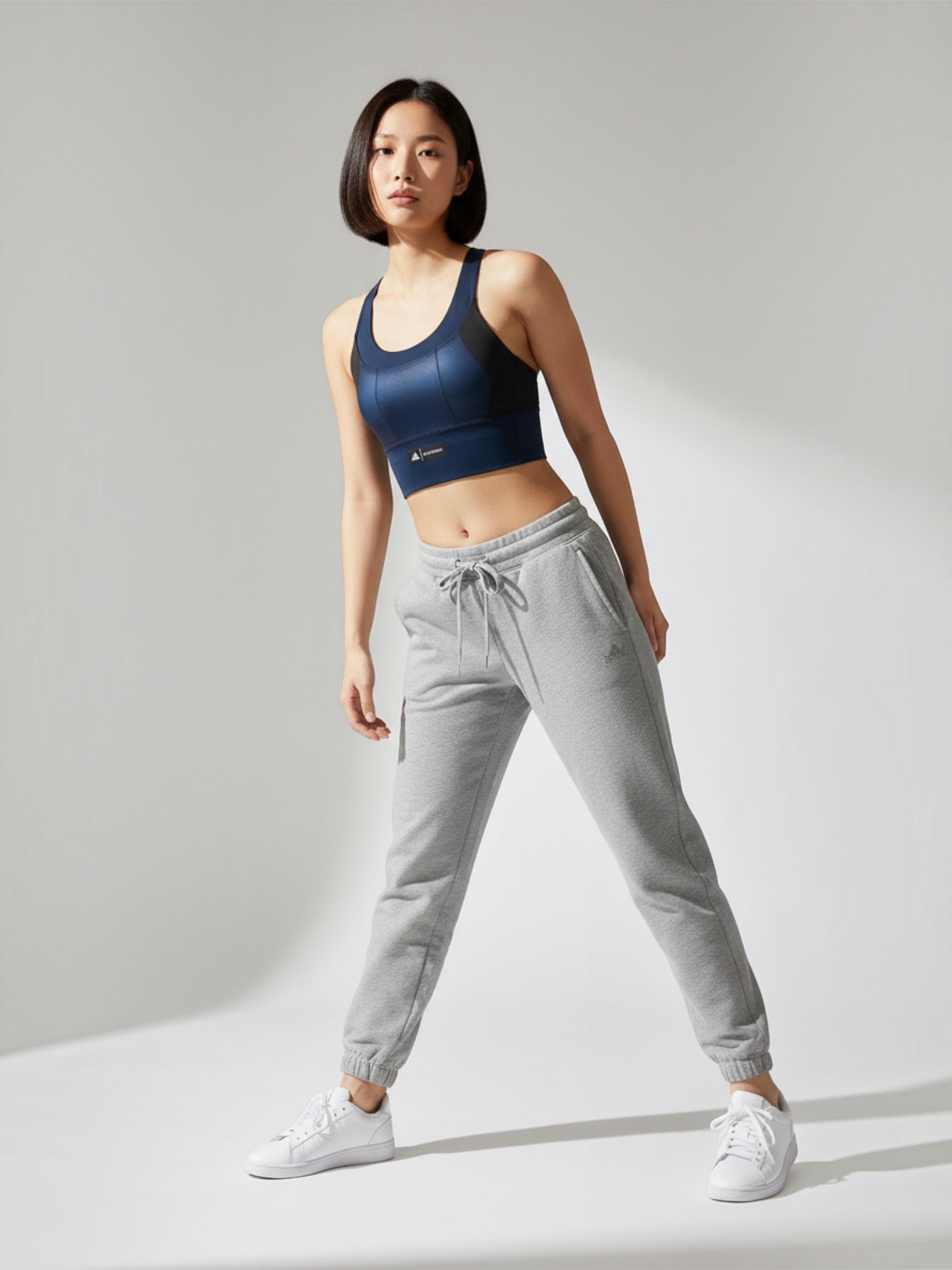 Model wearing FTFO || BIG BRAND LOW PRICE Adidas x Marimekko navy blue medium-support racerback sports bra