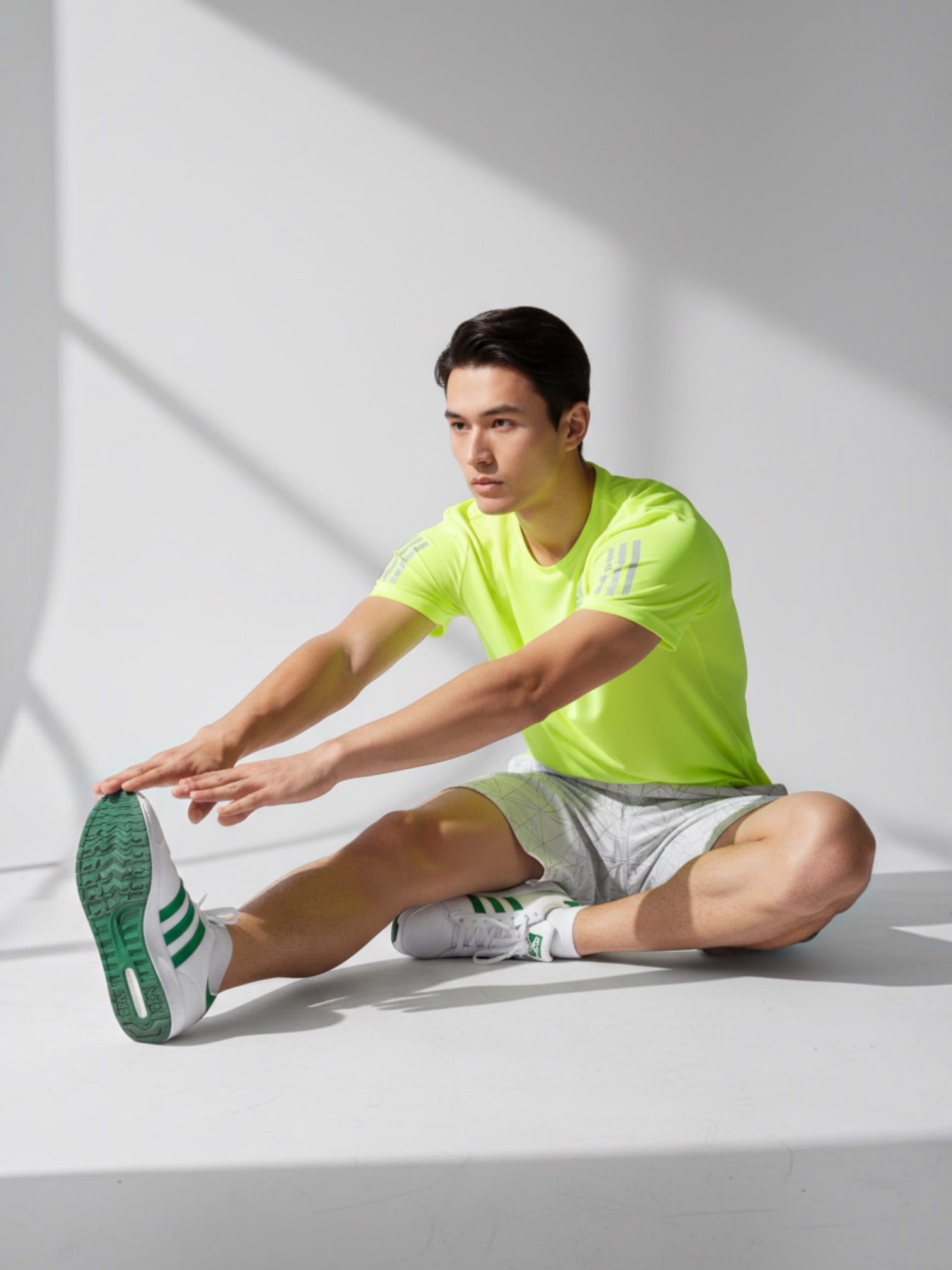 FTFO || BIG BRAND LOW PRICE neon yellow Adidas Own The Run running tee with reflective details on a male athlete