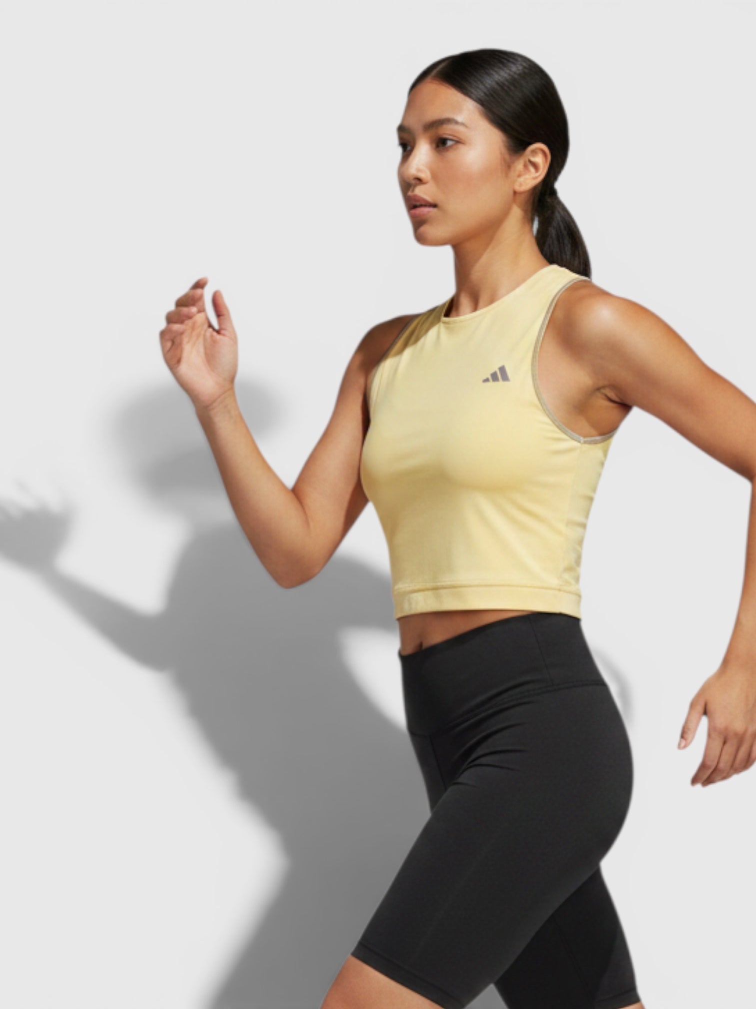FTFO || BIG BRAND LOW PRICE Adidas Adizero yellow crop running tank top worn by a female athlete in motion
